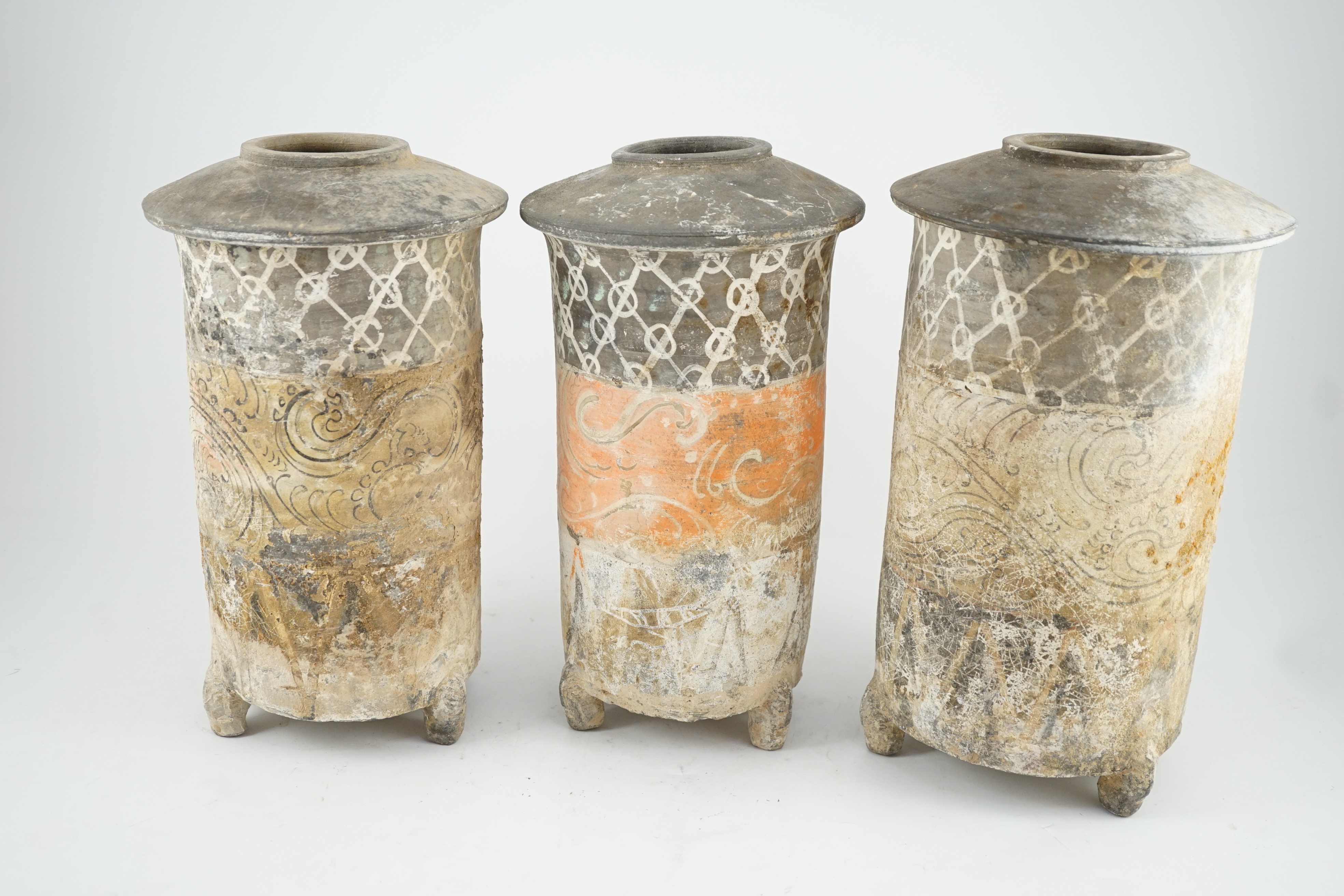 Three Chinese pigment painted grey pottery ‘granary’ jars, Han dynasty (200BCE - 220CE), 29.5 and 32cm high